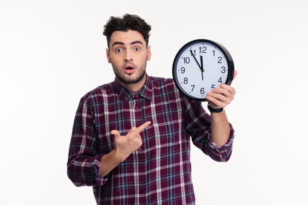 Man pointing at a clock